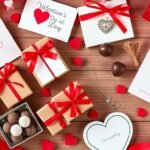 A collection of budget Valentine's Day gifts arranged beautifully including handmade cards, small gift boxes with red ribbons, and budget-friendly jewelry