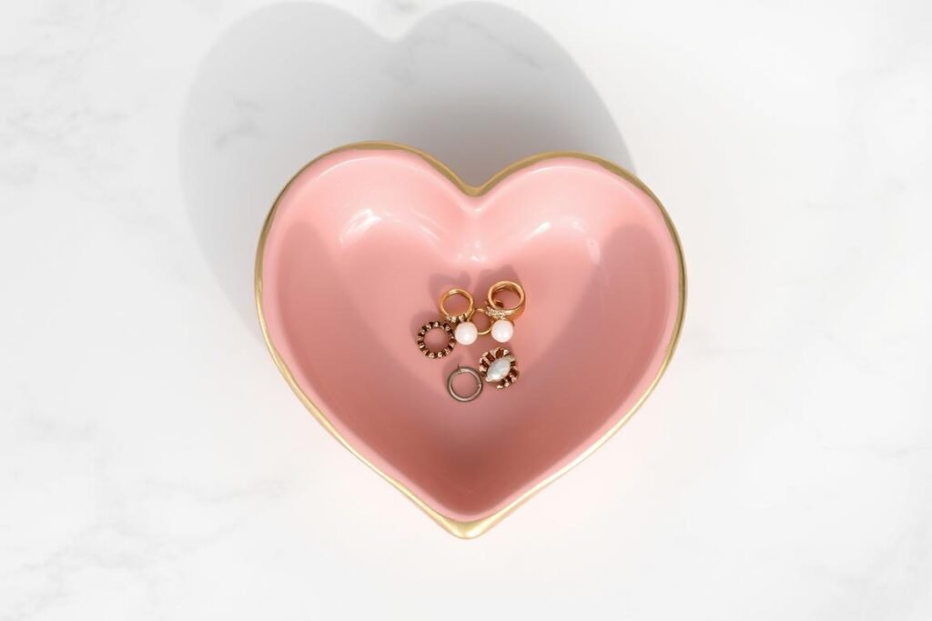 Heart-shaped clay trinket dish painted in pink with gold edges