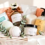 Spa gift basket with bath bombs, candles, and face masks arranged in a white wicker basket with eucalyptus sprigs